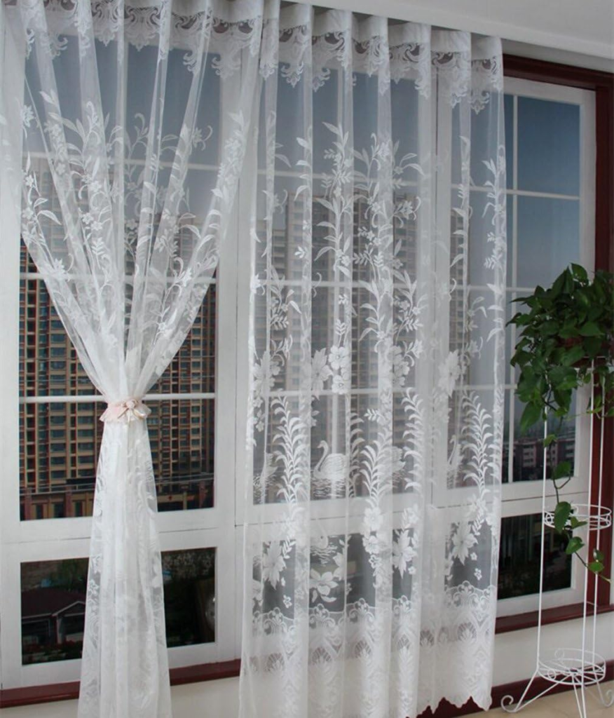 Exquisite lace curtain panels framing a window, adding a touch of timeless elegance to the interior.